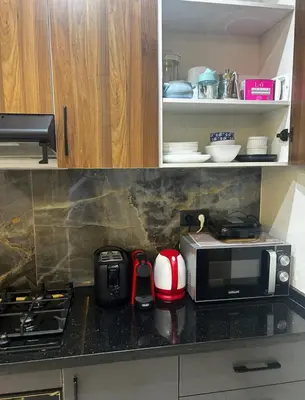 a kitchen with a counter top with a microwave at Charmant appartement en plein centre ville gueliz in Marrakech