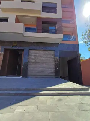 a large building with a garage in front of it at Charmant appartement en plein centre ville gueliz in Marrakech