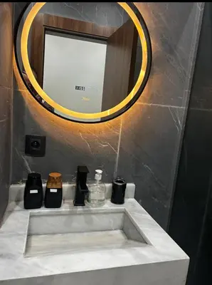 a bathroom with a sink with a mirror and a sink at Charmant appartement en plein centre ville gueliz in Marrakech