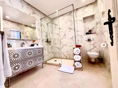 a bathroom with a shower and a sink and a toilet at Villa Shambhala in Marrakech