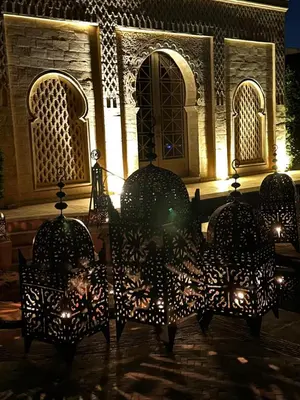 a group of chairs in front of a building at night at Villa Shambhala in Marrakech