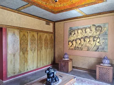 a room with a painting on the wall and a statue at Palais Oussoud in Sidi Yahia az Zaʼer