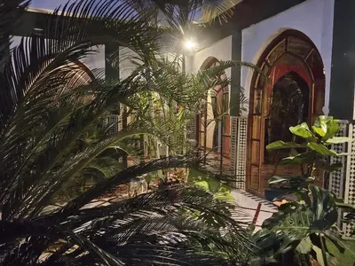 a building with a bunch of plants in front of it at Palais Oussoud in Sidi Yahia az Zaʼer