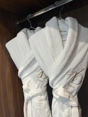 three white towels are hanging on a rack at AD Villa in Marrakech