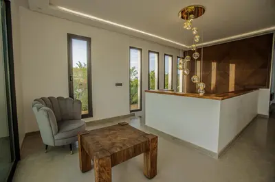 a living room with a table and a chair at AD Villa in Marrakech