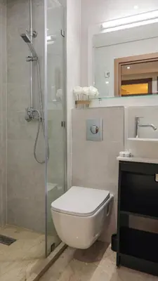 a bathroom with a shower and a toilet and a sink at Piscine chauffée - Sauna - Hammam - Appart Coeur de Gueliz in Marrakech