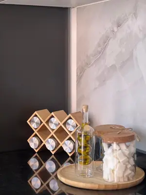 a table with a bottle of oil and a box of candles at Piscine chauffée - Sauna - Hammam - Appart Coeur de Gueliz in Marrakech