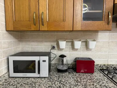 a kitchen counter with a microwave and a blender at Modern Garden-Level Apartment with Pool & Jacuzzi in Marrakech