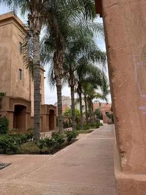 a row of palm trees in front of a building at Modern Garden-Level Apartment with Pool & Jacuzzi in Marrakech