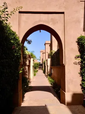 an archway over a walkway in an alley at Modern Garden-Level Apartment with Pool & Jacuzzi in Marrakech