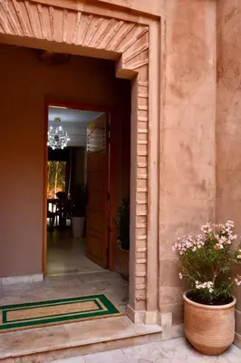 an entrance to a house with a potted plant at Modern Garden-Level Apartment with Pool & Jacuzzi in Marrakech