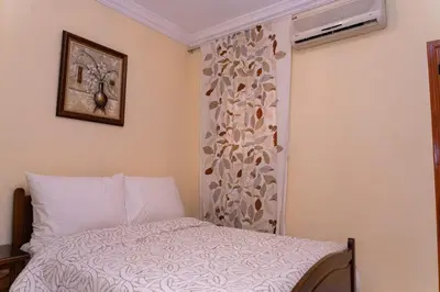 a bedroom with a bed and a window with a curtain at Riad butterfly Marrakech in Marrakech