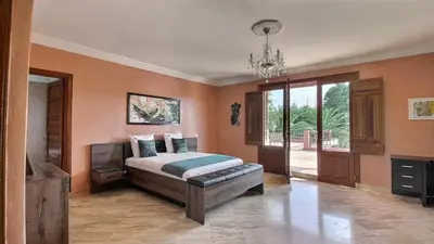 a bedroom with a bed and a television in it at Villa Dauphin in Marrakech
