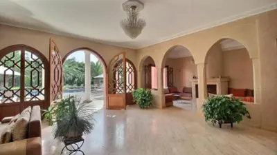 a large living room with two potted plants in it at Villa Dauphin in Marrakech