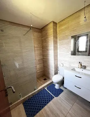 a bathroom with a toilet and a shower and a sink at Prestigious Apartment in Marrakech