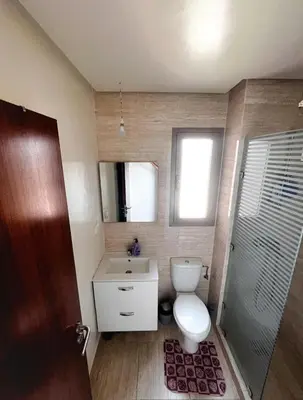 a bathroom with a toilet and a sink and a mirror at Prestigious Apartment in Marrakech
