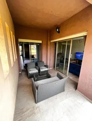 a patio with couches and chairs in a building at Prestigious Apartment in Marrakech
