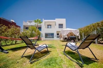 a group of lawn chairs sitting in the grass at Villa in Marrakesh in Marrakech