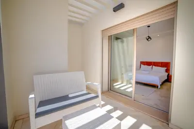 a white room with a bed and a glass window at Villa in Marrakesh in Marrakech
