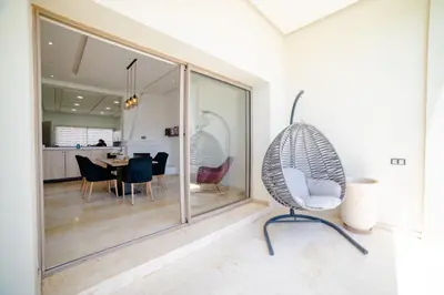 a dining room with a chair and a table at Villa in Marrakesh in Marrakech