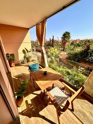 a balcony with a wooden table and chairs and a window at Pearl Garden Studio Luxueux Piscine Sunny Terrasse in Marrakech