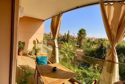 a balcony with a table and a view of the city at Pearl Garden Studio Luxueux Piscine Sunny Terrasse in Marrakech