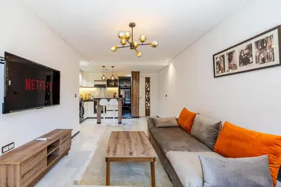 a living room with a couch and a table at Luxurious City Apartment in Marrakech