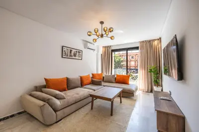 a living room with a couch and a table at Luxurious City Apartment in Marrakech