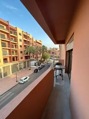 a balcony of a building with a view of a street at Bel Appartement Hivernage-Gueliz 2 chambres in Marrakech