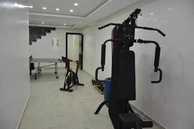 a gym with two exercise bikes and a table at Atlas Royale Marrakech in Marrakech