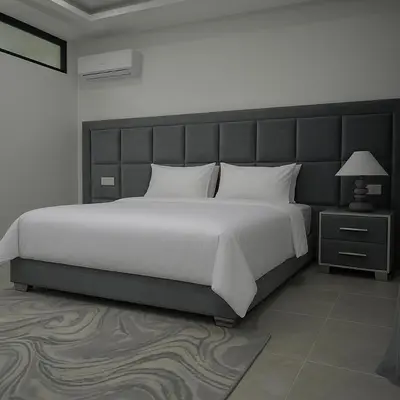 a bedroom with a large white bed with a large headboard at Atlas Royale Marrakech in Marrakech