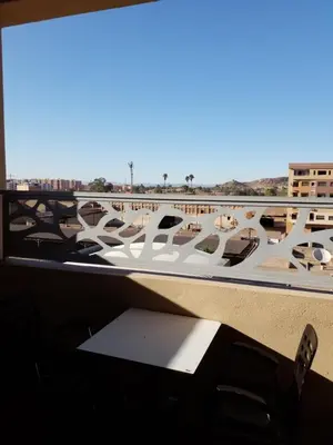 a room with a view of the desert from a window at Magnifique appartement in Marrakech