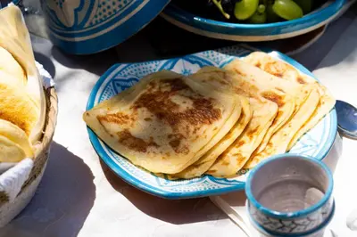 a stack of pancakes on a blue and white plate at Villa oasis private pool secure complex in Marrakech