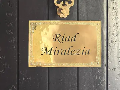 a gold sign on a door with the word raid miracles at Riad Miralezia in Marrakech