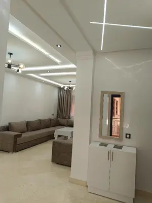a living room with a couch and a mirror at Riad Arfoud appartement haut standing 3 chambres avec piscine à gueliz nord in Marrakech