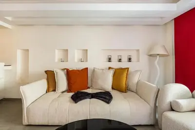 a living room with a white couch with colorful pillows at Magnifique appartement Gueliz in Marrakech