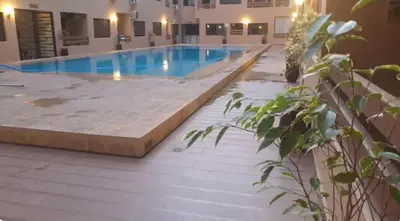 a large swimming pool in a building at apparte 2 chambres de luxe en face la gare gueliz in Marrakech