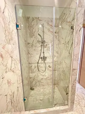 a shower in a bathroom with a marble wall at Les Douces Nuits De Marrakech in Marrakech