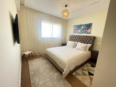 a small bedroom with a bed and a window at Les Douces Nuits De Marrakech in Marrakech