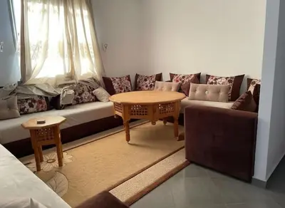 a living room with a couch and a table at Apartment - Sleeps up to 8 & parking in Marrakech
