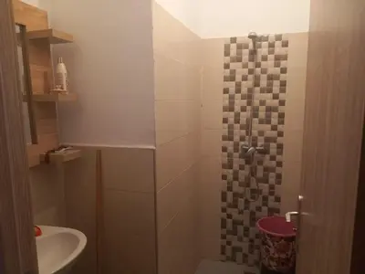 a bathroom with a shower with a toilet and a sink at Apartment - Sleeps up to 8 & parking in Marrakech