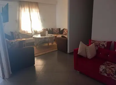 a living room with a couch and a table at Apartment - Sleeps up to 8 & parking in Marrakech