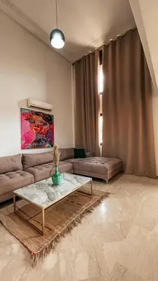 a living room with a couch and a table at Duplex Jasmine in Marrakech
