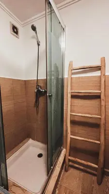 a shower with a glass door in a bathroom at Duplex Jasmine in Marrakech