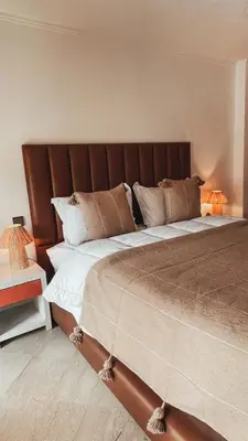 a large bed in a bedroom with two lamps at Duplex Jasmine in Marrakech