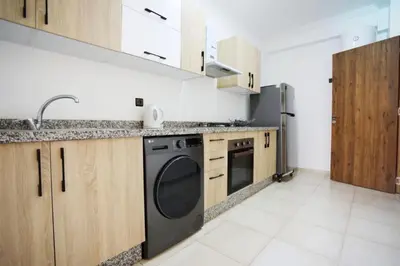 a kitchen with a sink and a dishwasher at Appartement de lux in Marrakech