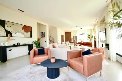a living room with two chairs and a couch at Somptueuse Family Villa Cherifa avec piscine chauffée in Marrakech