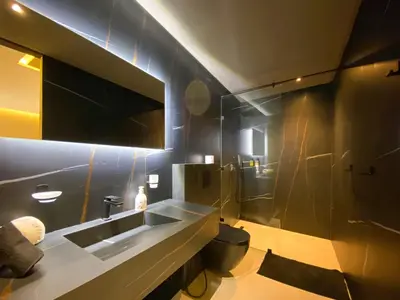 a bathroom with a sink and a toilet at Triplex de luxe Santorini piscine privée chauffée 3 chambres in Marrakech
