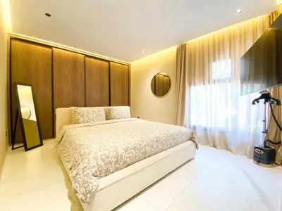 a bedroom with a bed and a large window at Triplex de luxe Santorini piscine privée chauffée 3 chambres in Marrakech
