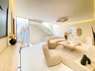 a living room with white furniture and a large window at Triplex de luxe Santorini piscine privée chauffée 3 chambres in Marrakech
